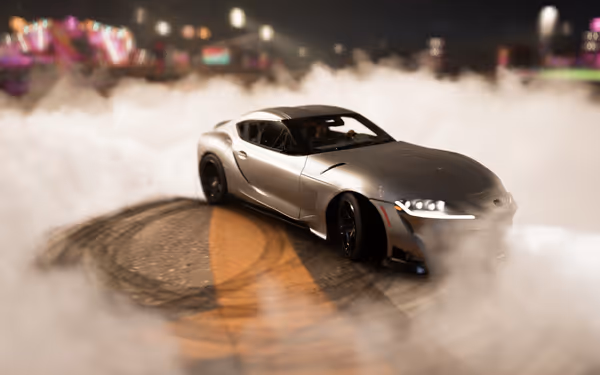 Silver sports car drifting surrounded by smoke at night with colorful lights in the background.