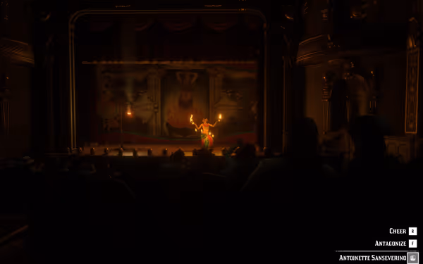 In a dark room, a female performer performs with fire on stage while the audience watches, sitting in their chairs.