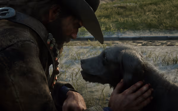 A man in a weathered coat and cowboy hat, with a bandolier, kneels on the grassy surface, touching a dog's neck.
