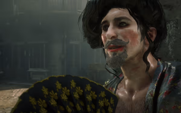 A character with long hair and red lips sits on the street, holding a hand fan.