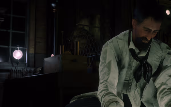 Person in lab coat sits in dimly lit lab with glowing lights.