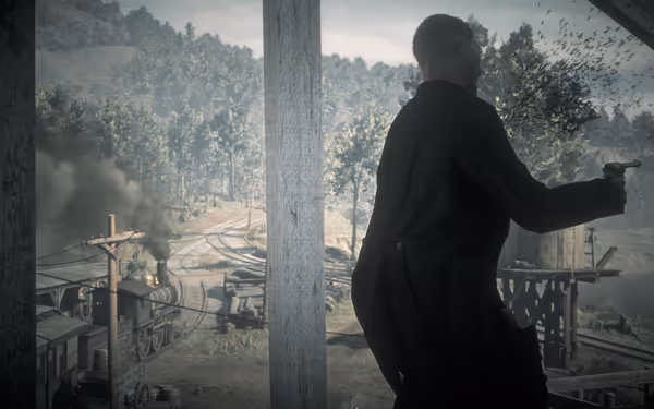 Man with gun stands on platform, train tracks in background.