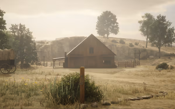 A wooden cabin stands in a dry, grassy field with a covered wagon nearby.