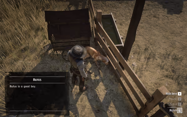 A cowboy wearing a hat stands beside a tan dog near a wooden fence and water trough.