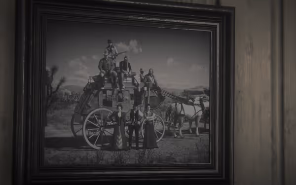 A framed photo shows people on and around a stagecoach with horses outdoors.