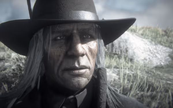 An older man with weathered skin, long gray hair, and a wide-brimmed hat.