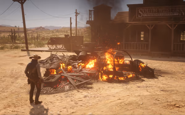A man stands near burning debris outside the South Western Railroad Company building.