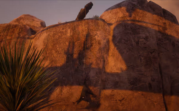 A person hangs by a rope against a steep rocky cliff at sunset.
