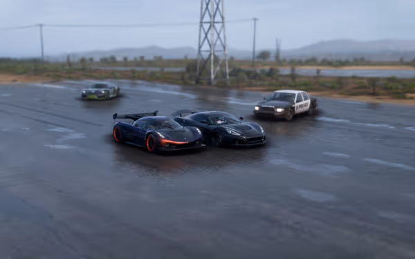 Two racing cars, a police car, and a green sports car on a wet road with a large tower behind