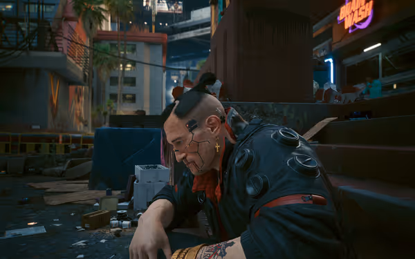 A cybernetic man with facial implants sits against a pillar in a cluttered urban alley.