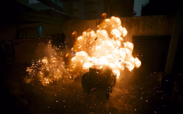 A large explosion engulfs a metal container, with fire, sparks, and debris flying