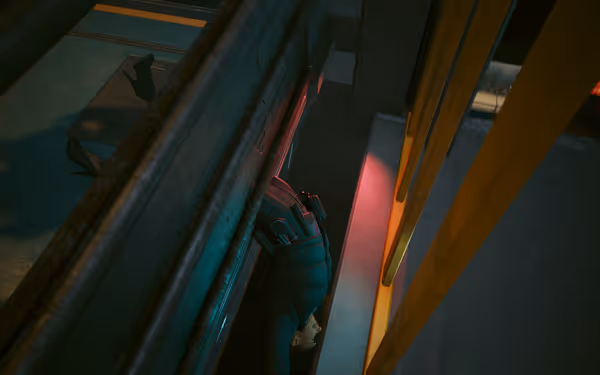 A woman in tactical gear hangs upside down near metal railings with dim lighting