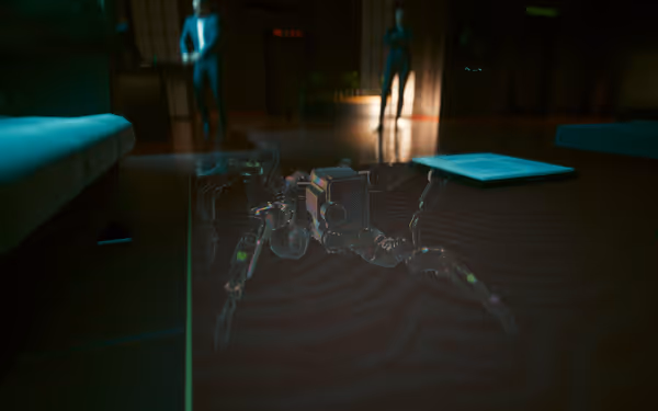 A holographic robotic spider is projected on a table, with two figures in the background.