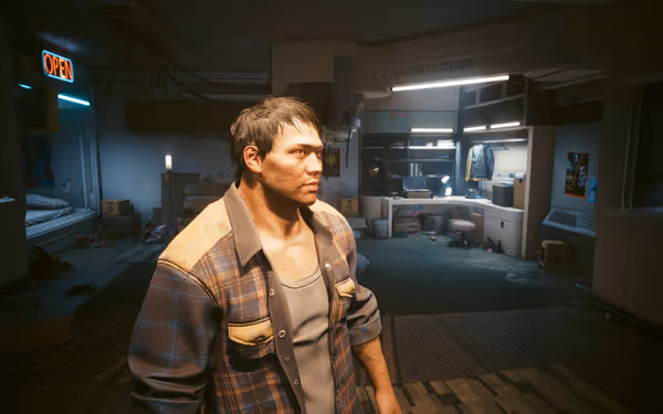 A rugged man in a plaid jacket stands in a cluttered futuristic apartment.
