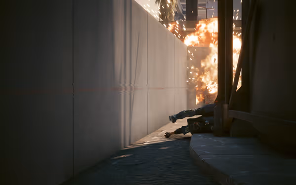 A fiery explosion engulfs a narrow alley as a fallen armored figure lies nearby.