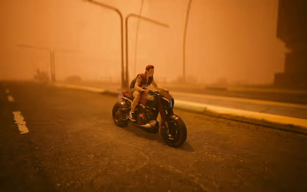 A person with a cybernetic face rides a futuristic motorcycle through a dusty, orange-lit street.