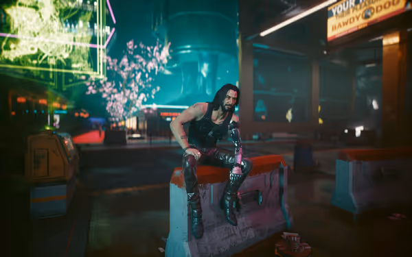 A man with long hair and a cybernetic arm sits on a concrete barrier.