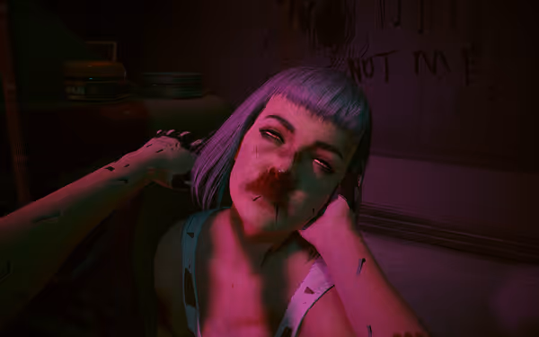 A woman with short purple hair and bruised face is held by a cybernetic arm