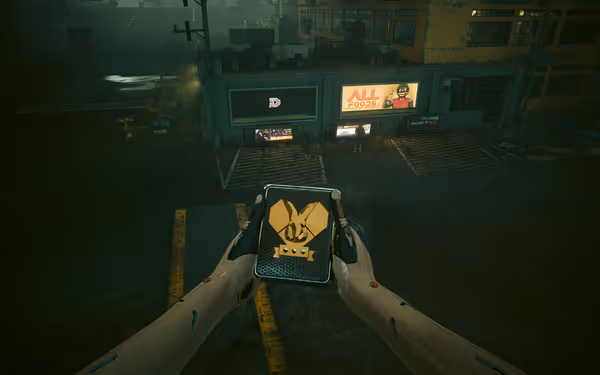 A person with cybernetic arms holds a device with a golden emblem in the rain