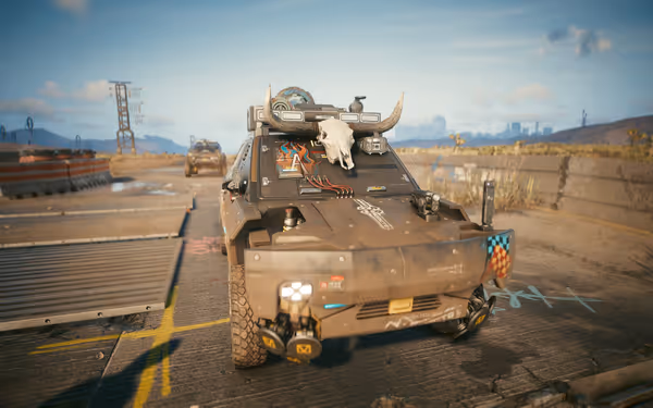 A heavily armored vehicle with a bull skull on the hood sits on a highway.
