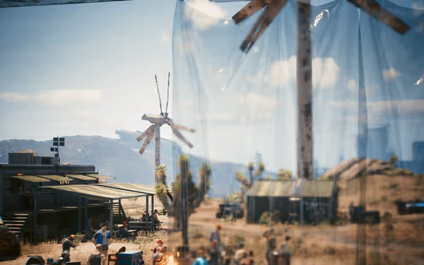 A dusty encampment with people gathered, seen through a clear plastic sheet reflection.