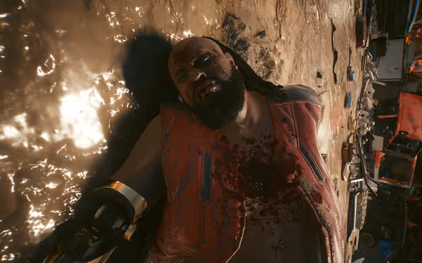 A bloodied man with a cybernetic arm lies lifeless in a junkyard.