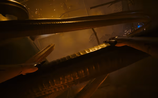 A pair of cybernetic arms grip thick cables in a dim, industrial environment with sparks.