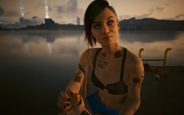 Tattooed woman with glowing blue eyes sits near water at sunset, wearing sportswear.