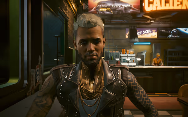 Man with platinum hair, gold chains, and cybernetic neck sits in a neon-lit diner.