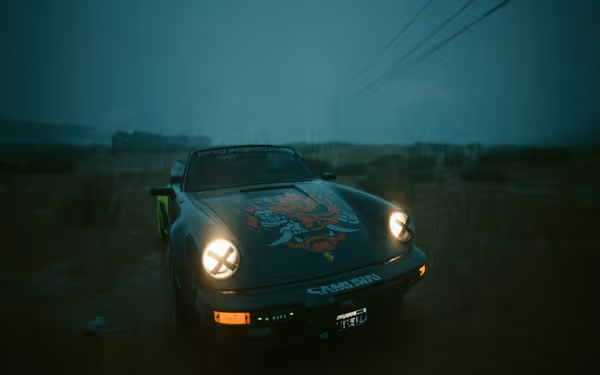 Black Porsche with glowing headlights and red demon decal parked in rain-soaked desert.
