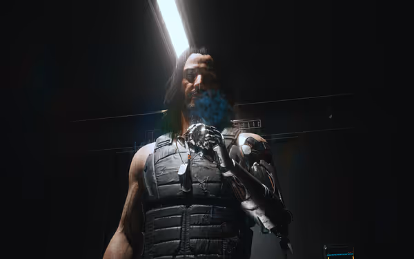 A man with long hair and a metal arm smokes under a harsh ceiling light.