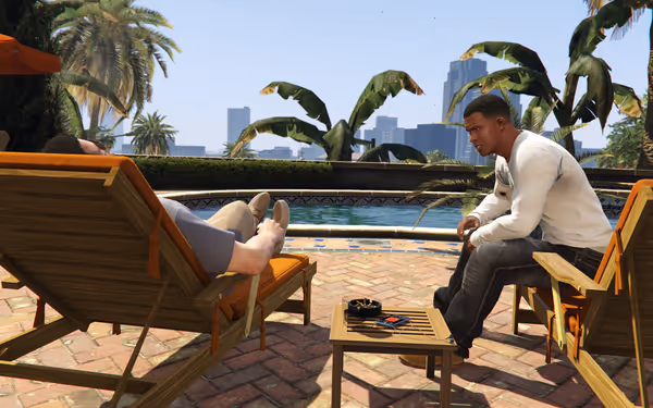 Two men sit by a pool on lounge chairs, talking seriously under sunny skies.