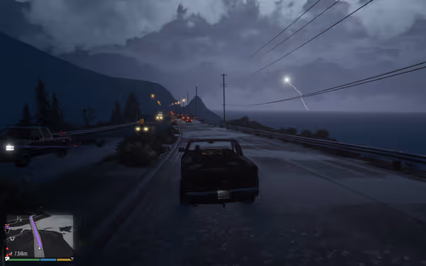 A black pickup drives a rainy highway as lightning strikes above the ocean.