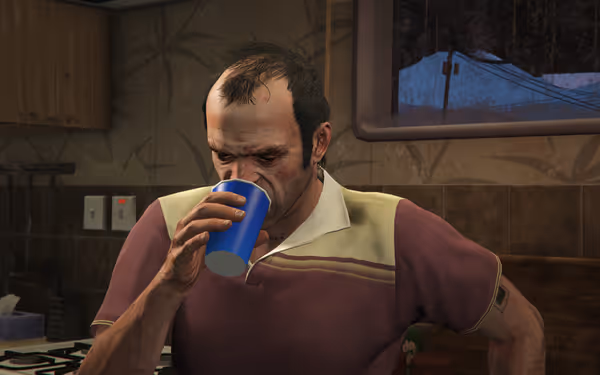 A disheveled man with bruises drinks from a blue cup in a dingy kitchen.
