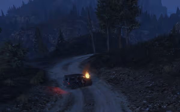 A black SUV with its hood on fire is stopped on a dirt road in the forest.