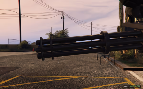 A large six-barrel minigun points forward in a quiet street with power lines.