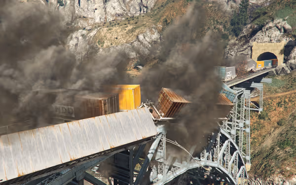 Freight train derailed on iron bridge with containers falling and thick black smoke rising.