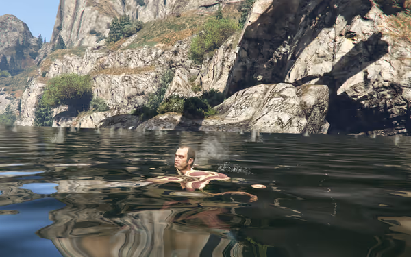 A person is swimming in a calm lake surrounded by rocky cliffs and green bushes.