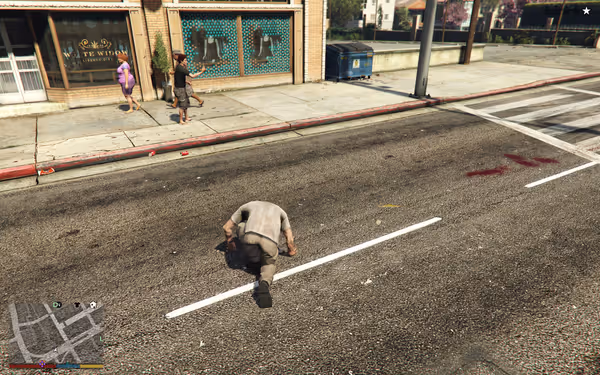 Man on hands and knees in street, blood nearby, people watching from sidewalk.