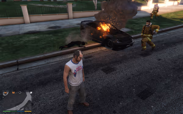 A man stands on the street with a burning car, firefighters, and a fallen person nearby.