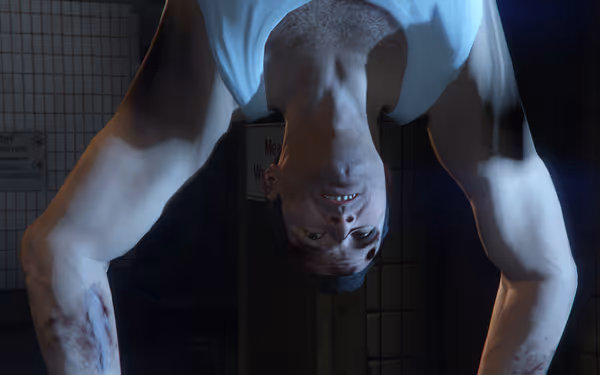 A man in a white tank top hangs upside down with visible injuries.