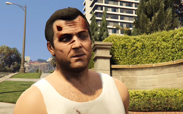 A man wears a white tank top with blood stains, standing outside near green bushes.