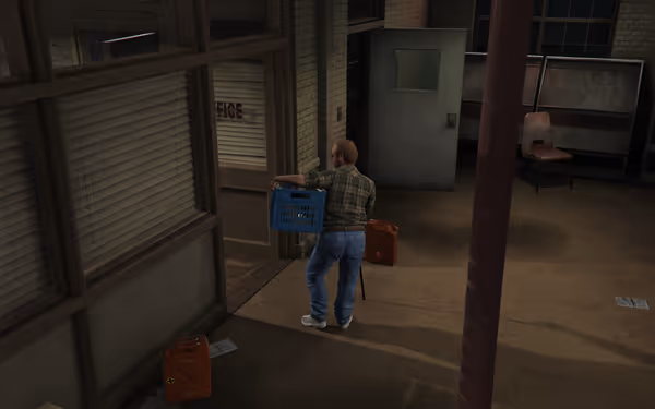 A man in a plaid shirt holds a blue bin near an office, with red containers nearby.