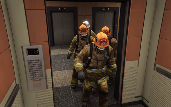 Four firefighters in full gear exit an elevator on floor 1 of a building.