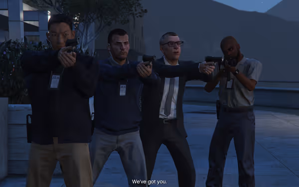 Four armed agents in tactical gear point guns, with one man speaking.