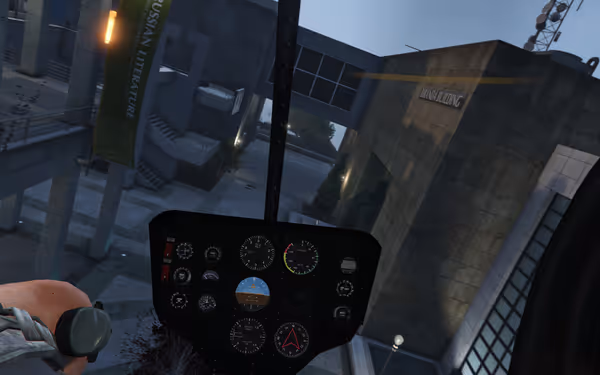 A tilted helicopter cockpit view approaches a modern campus with walkways and buildings.