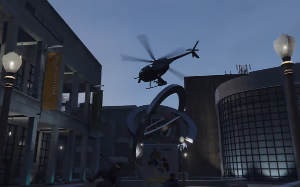 A helicopter hovers above a statue, with banners and two armed figures below.