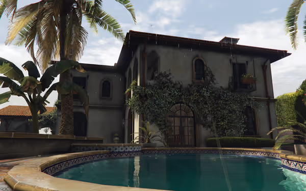 A Mediterranean-style villa with a swimming pool surrounded by palm trees and lush landscaping.