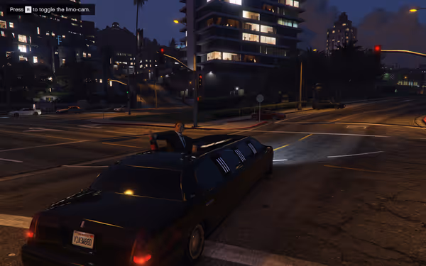 A person in a suit holds a bottle out of a sunroof on a black limousine.