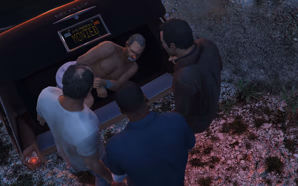Three men stand around a car trunk holding a bound, gagged shirtless man.